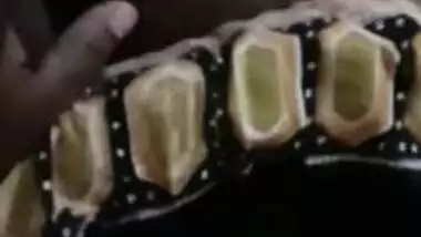 Desi woman lies in bed with legs spread while man touches XXX parts