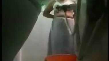 Desi MILF bares XXX charms taking a shower in front of a era